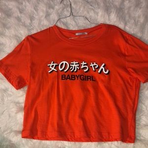 Orange graphic Fashion nova top. (Never worn)